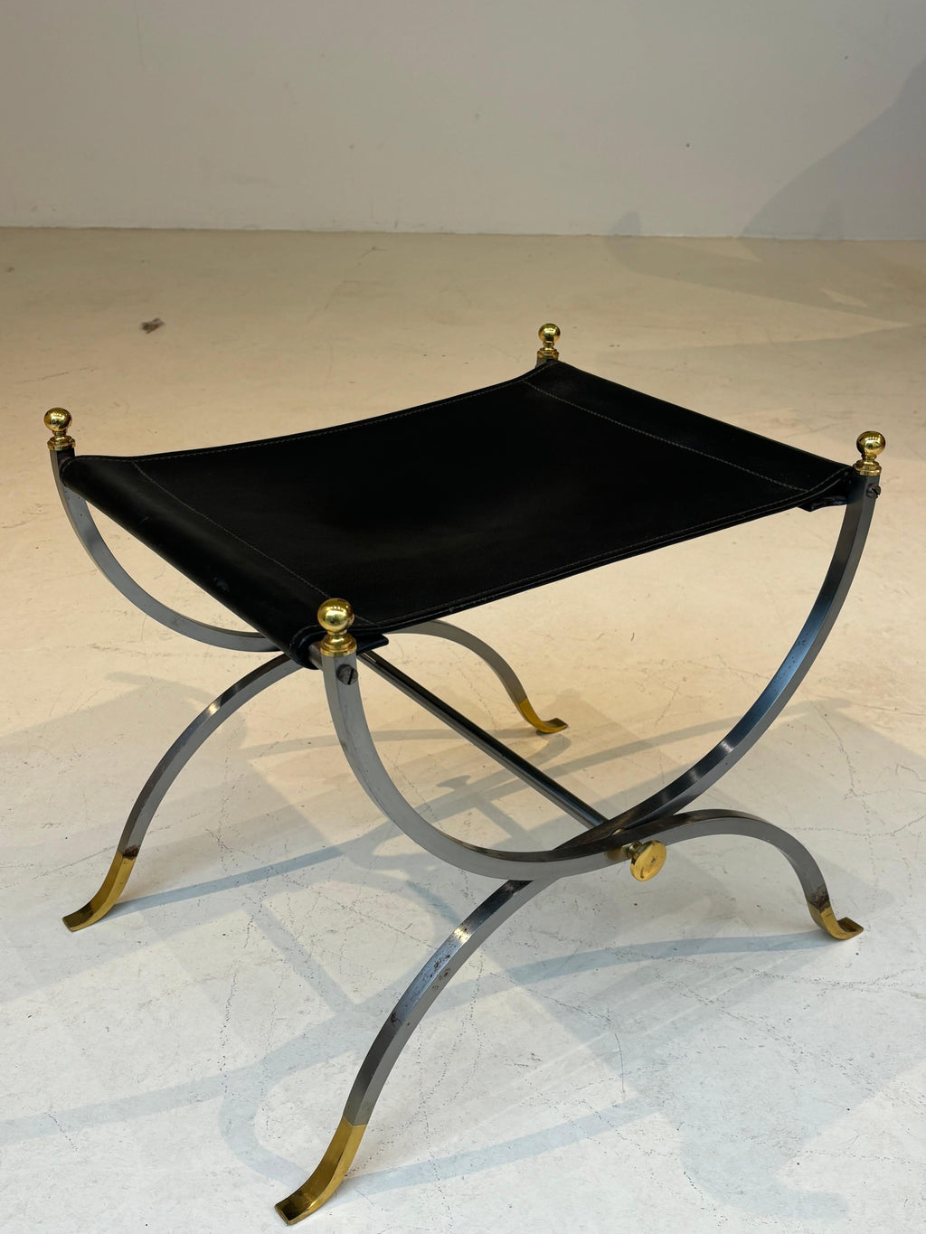 Stool by la maison Charles in stainless steel, brass and leather