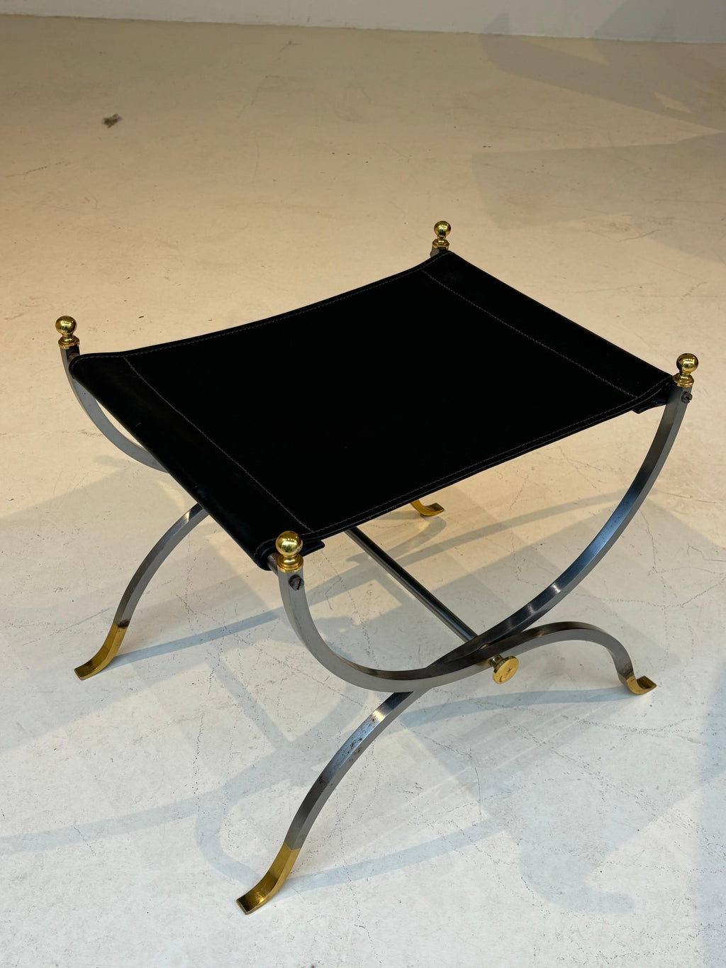 Stool by la maison Charles in stainless steel, brass and leather