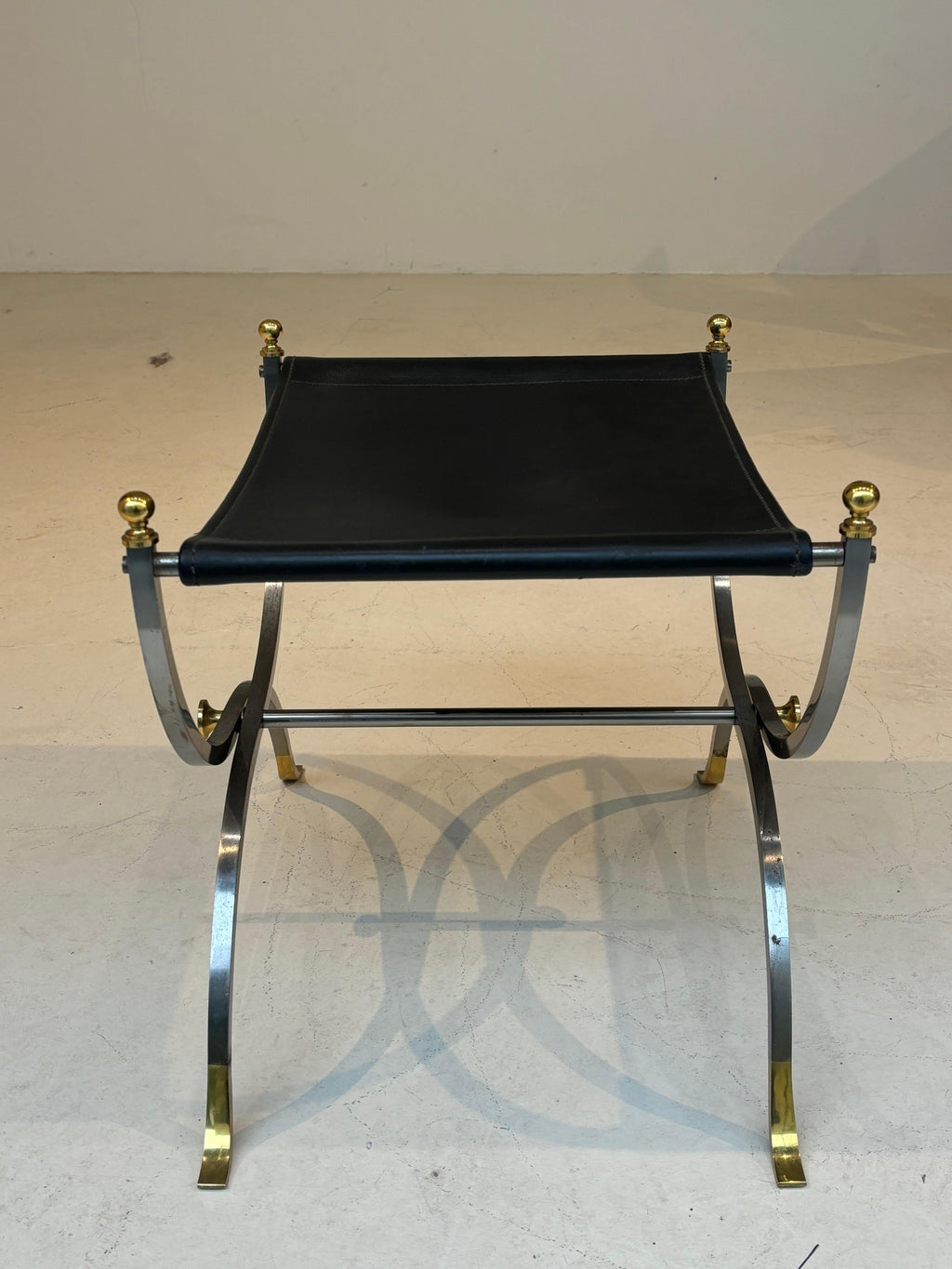 Stool by la maison Charles in stainless steel, brass and leather
