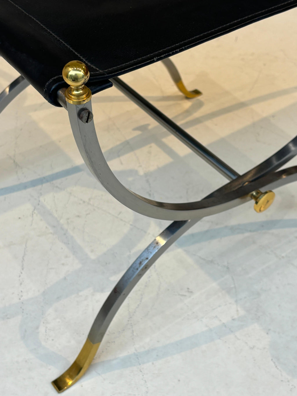 Stool by la maison Charles in stainless steel, brass and leather