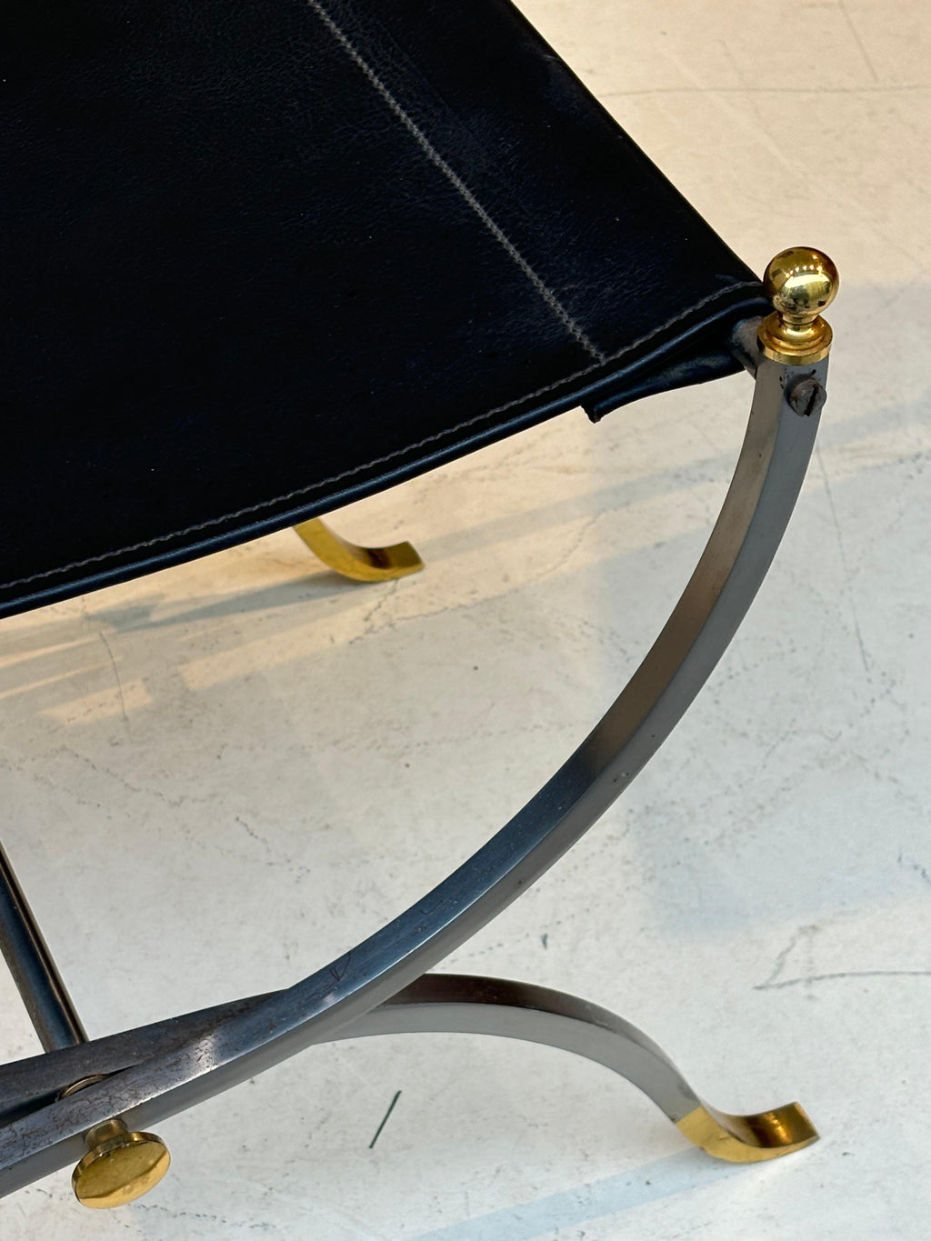 Stool by la maison Charles in stainless steel, brass and leather